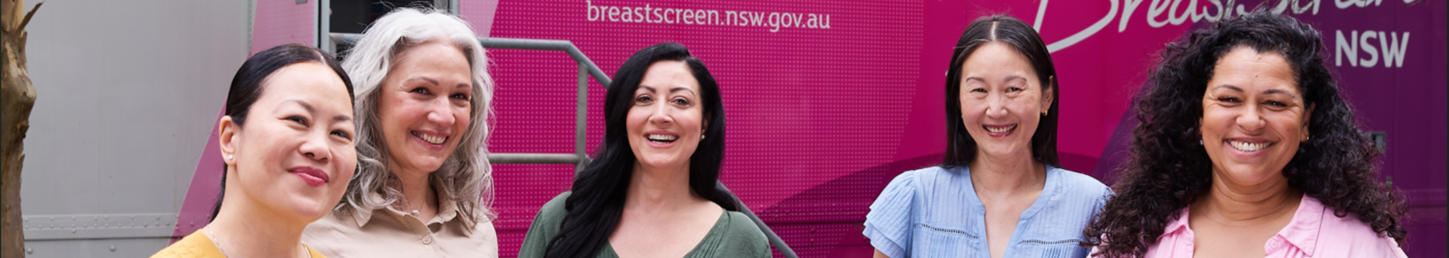 Four women standing in front of a BreastScreen NSW mobile van