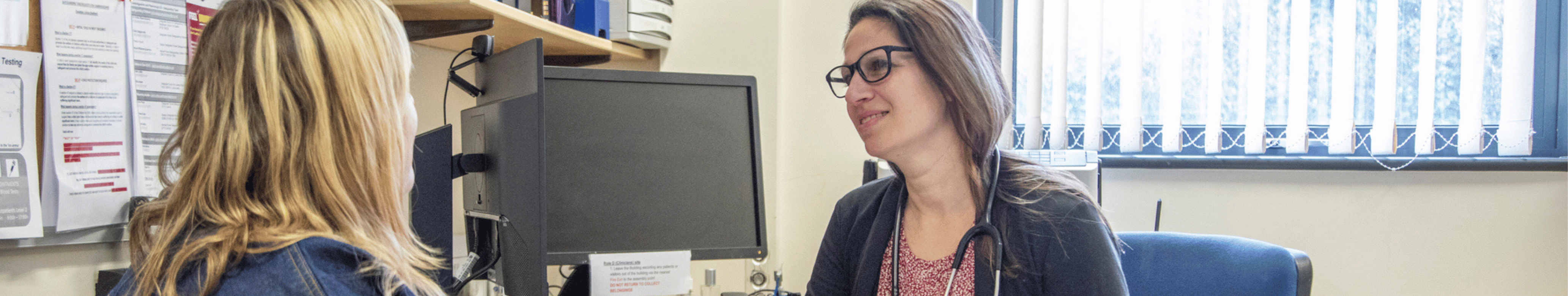 gp doctor talking to a client in a healthcare setting