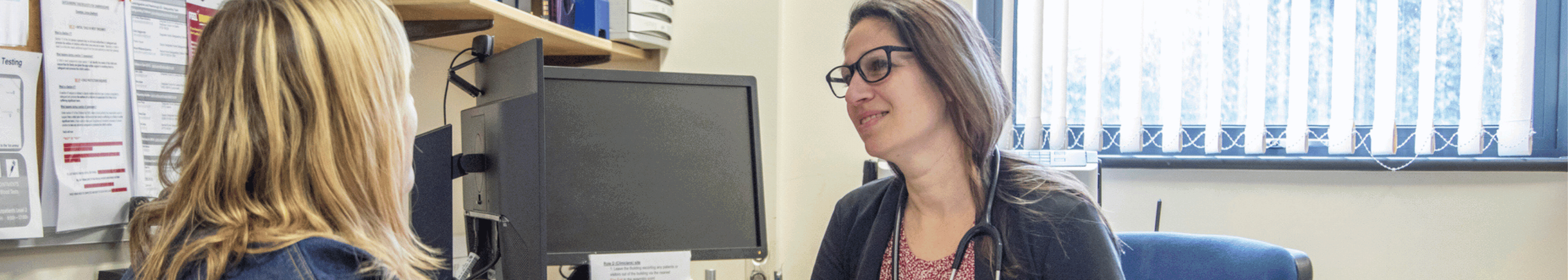 gp doctor talking to a client in a healthcare setting