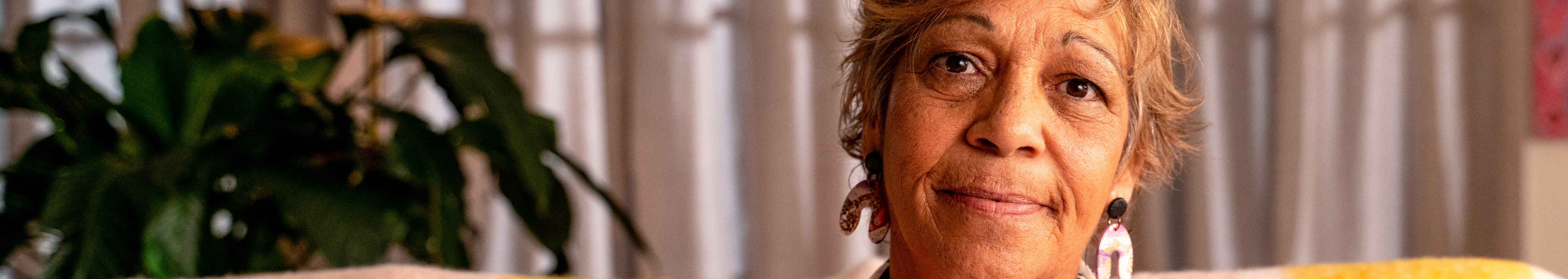 Image of breast cancer survivor, Jacqui, smiling at the camera