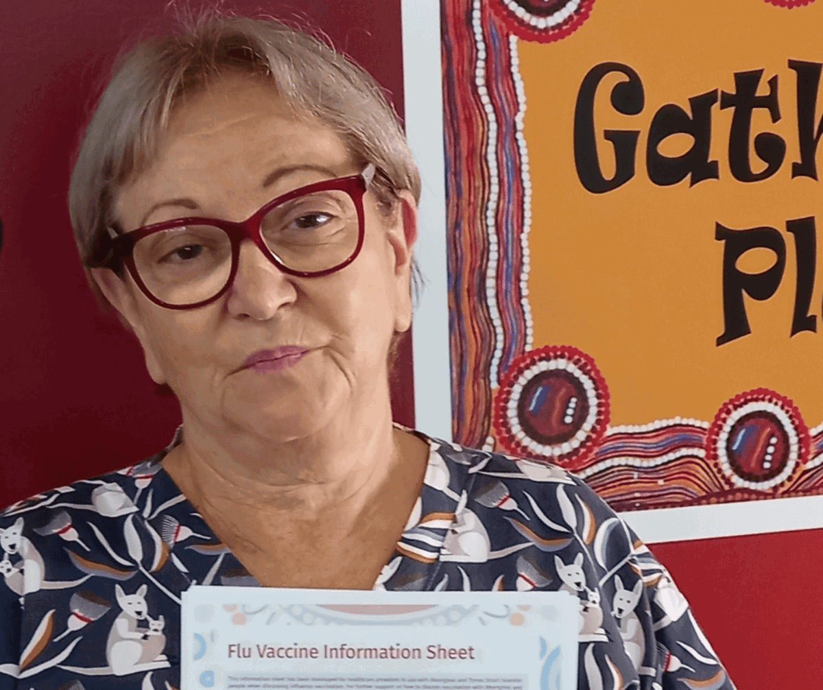 Image of June who is hold an information sheet